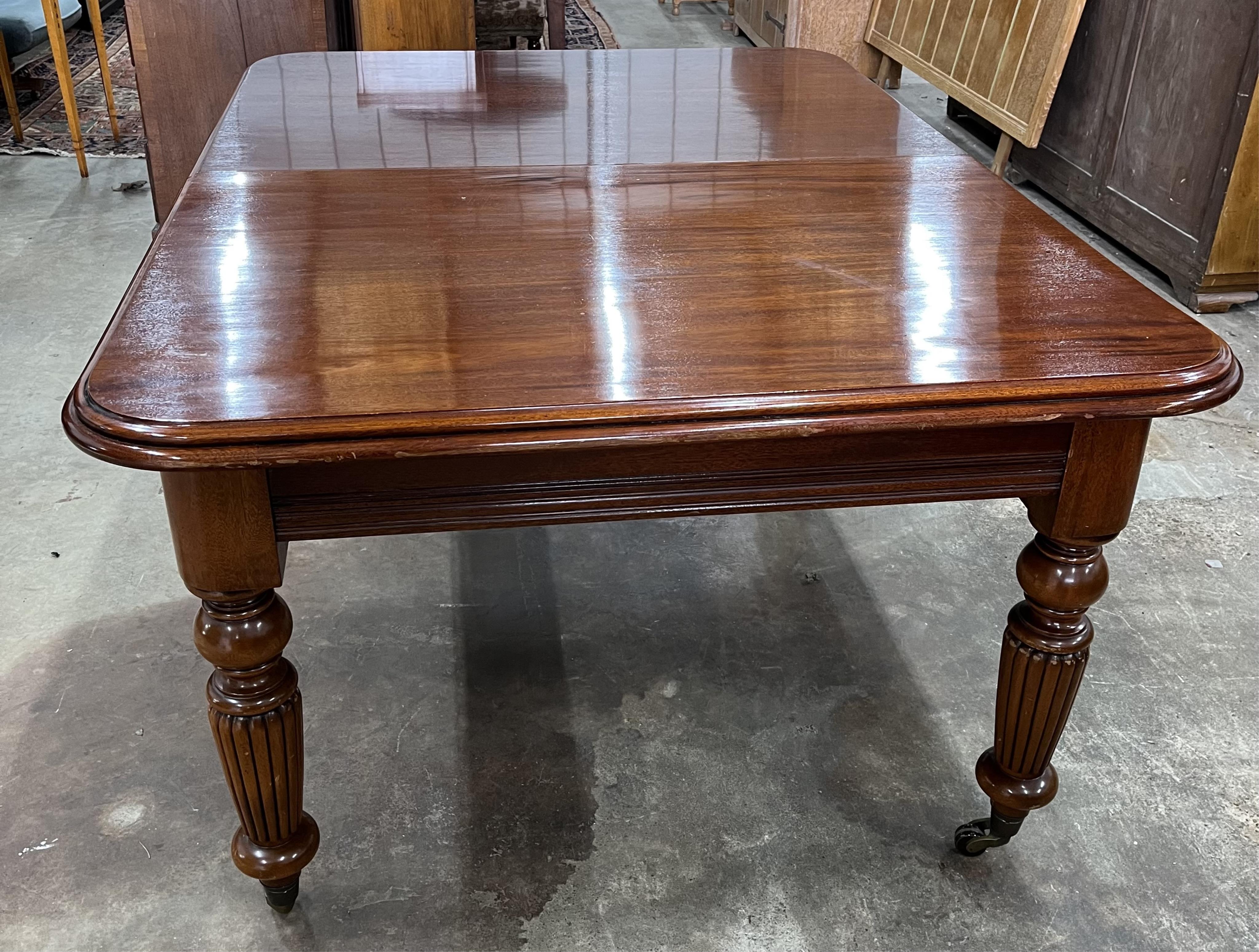 A reproduction Victorian style mahogany extending dining table, 310cm extended, three spare leaves, depth 123cm, height 79cm. Condition - fair to good